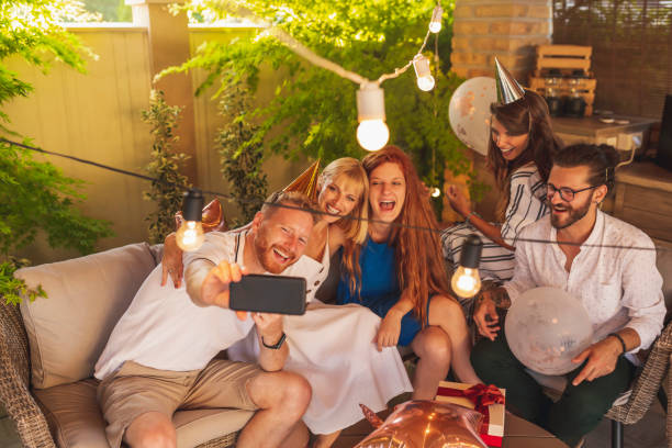 istock People having fun taking selfies at birthday party 1312106408