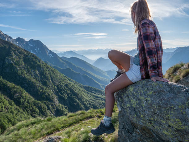 istock Hiker female contemplates view from mountain top 1312106410