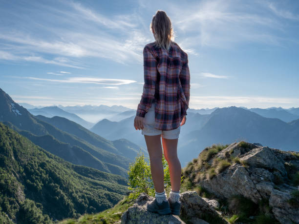 istock Hiker female contemplates view from mountain top 1312106497