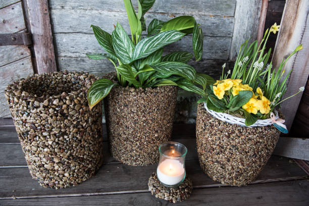 Flower vases made of pebbles.