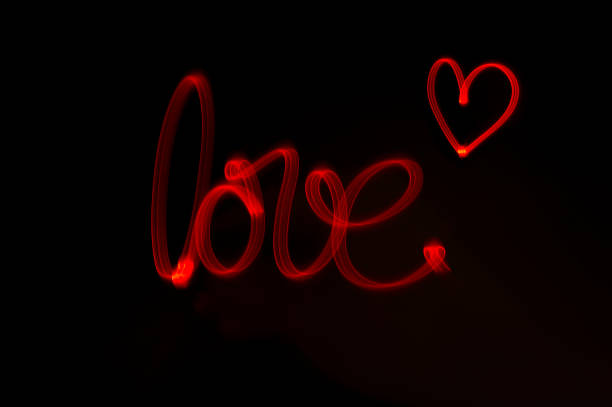 lightpainting - love word "love" written with red light lightpainting stock pictures, royalty-free photos & images
