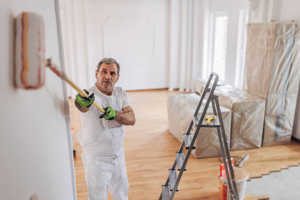 istock Mature male painter painting a wall 1312110838