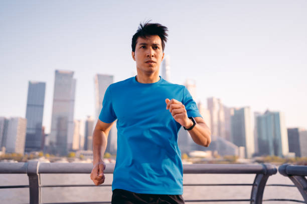 istock Young muscular sportsman jogging by river. 1312110912