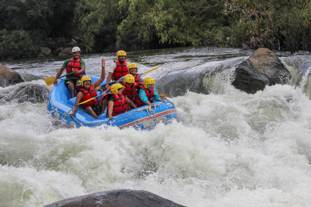 an action captured in motion, river rafting in white waters is a popular adventure tourism for the brave hearted visiting coorg in karnataka,india. - rafting imagens e fotografias de stock