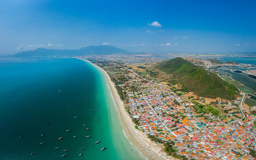 Drone view of Doc Let beach, with fishing boats nailing, basket boats, fishing village and sand - Khanh Hoa province, central Vietnam