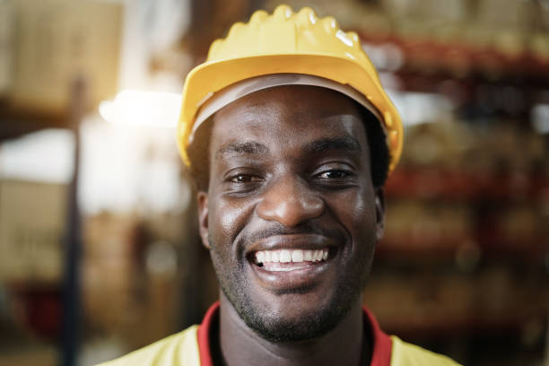 istock Portrait of happy african worker man looking at camera inside warehouse store - Focus on face 1312113236
