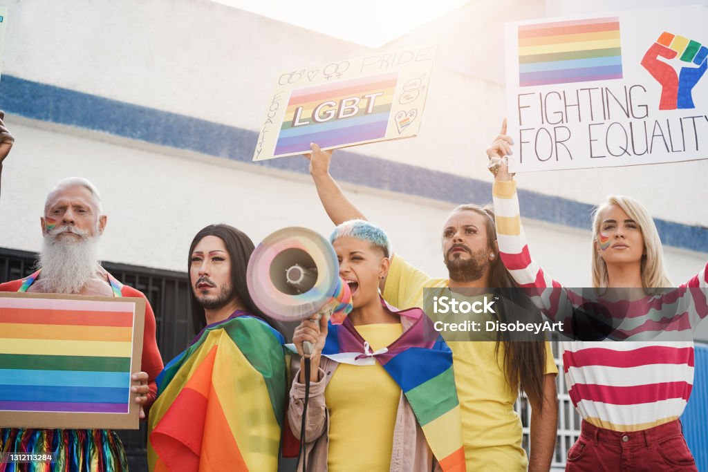 Gay and transgender people protest at pride event outdoor - Main focus on drag queen face Gay Pride Parade Stock Photo