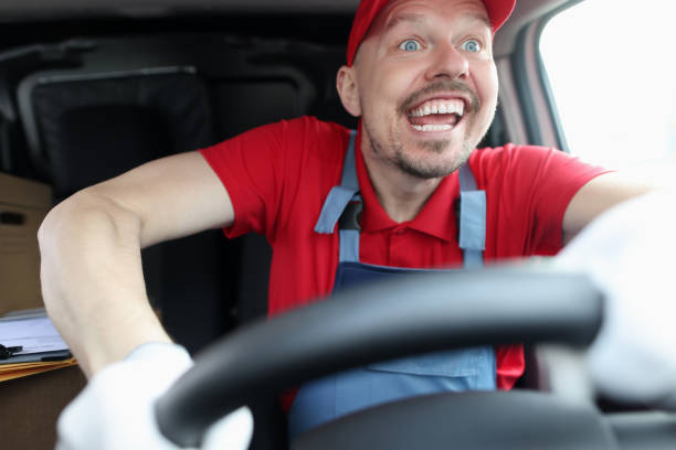 istock Happy young male courier driving fast car 1312113518