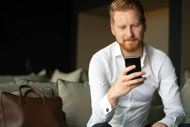istock Young businessman sending message with mobile phone 1312115097