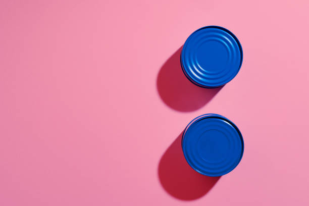 istock Aesthetic concept with blue painted tin can on pink background 1312116202