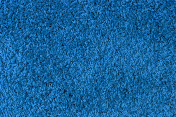 istock Monochrome pattern texture of surface of blue fabric carpet with threads. 1312116437
