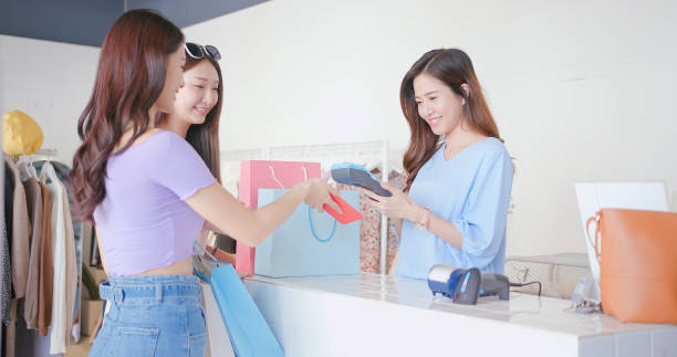 istock women pay by smartphone 1312118574