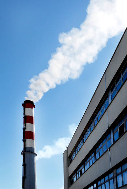 Chimney with smoke and part of the factory building