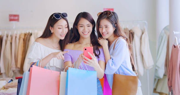 istock three women look at smartphone 1312119871