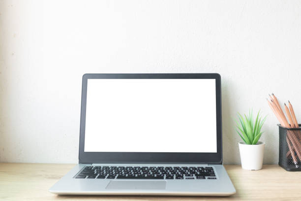 istock Laptop computer with white blank screen on desk in workspace and copy space concept 1312120048