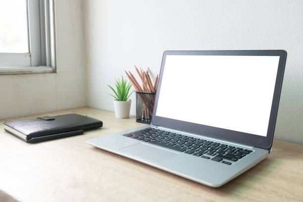 istock Laptop computer with white blank screen on wood desk. Workspace, workplace, desktop office concept. 1312120359