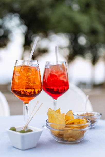 istock Two refreshing Italian cocktails with snacks on the table (Vertical photo) 1312122253