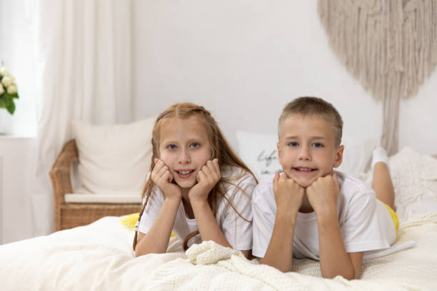 istock Children lying on their bellies in a bedroom 1312123236