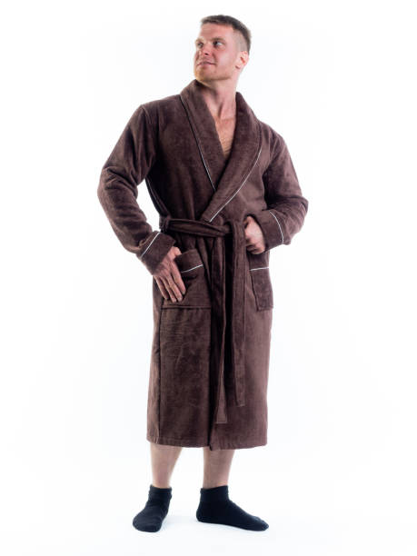 istock strong man in a Bathrobe on an isolated white background with a smile on his face. 1312124730