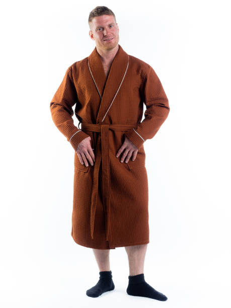 istock strong man in a Bathrobe on an isolated white background with a smile on his face. 1312124731