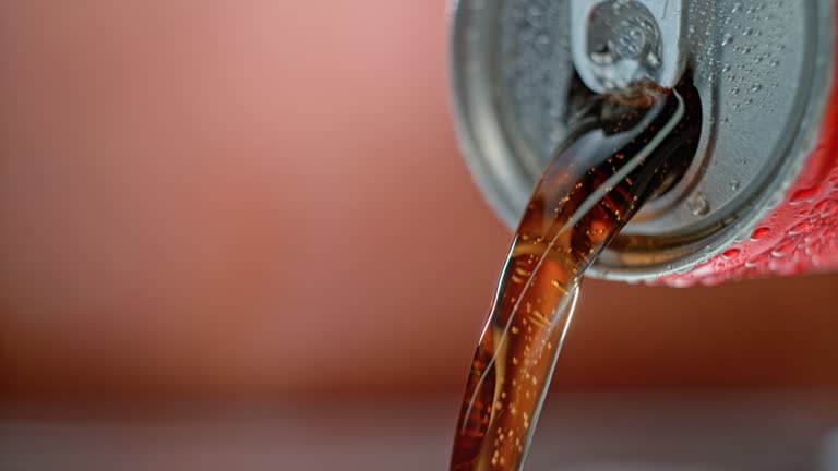 SLO MO LD Bubbly liquid being poured out of a can