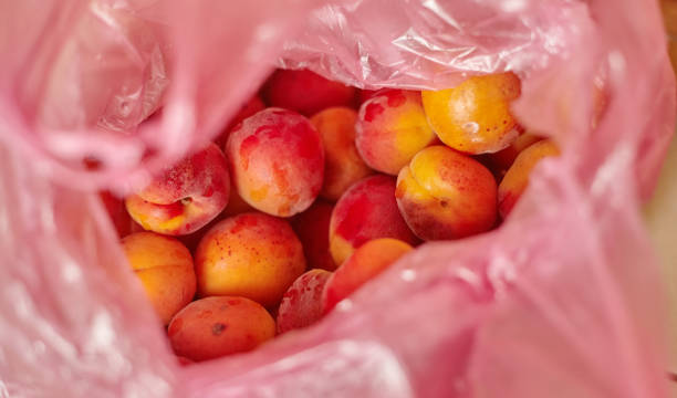 istock fresh ripe apricots in a cellophane bag, Closeup 1312124812