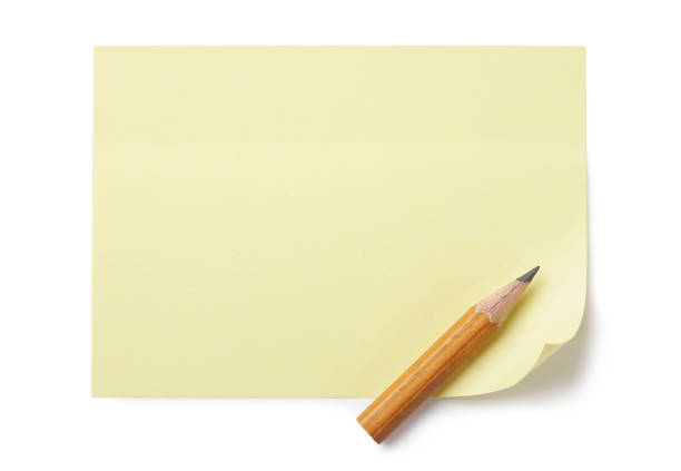 istock Empty yellow paper with small pencil over its bottom corner. 1312126668