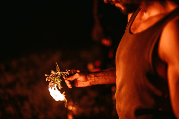 istock Man burning branch with flowers 1312126701