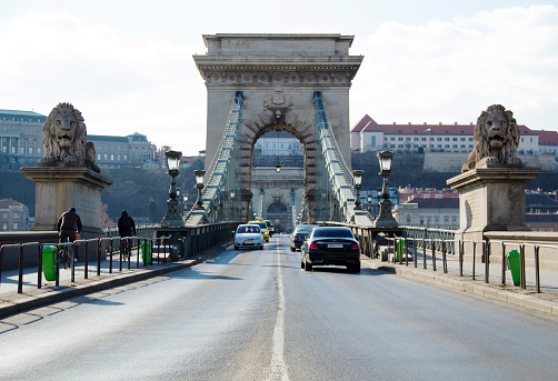 Széchenyi Chain Bridge with Traffic in Budapest, Hungary in March 2021 - The Széchenyi Chain Bridge is a chain bridge that spans the River Danube between Buda and Pest, the western and eastern sides of Budapest, the capital of Hungary. It was opened in 1849.