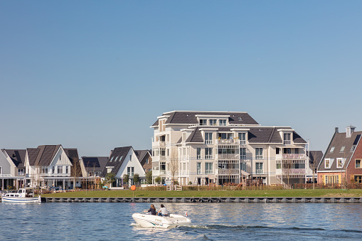 Harderwijk, The Netherlands - March 30, 2021: Luxury apartments and detached family homes located on the Veluwemeer waterfront in Harderwijk, The Netherlands