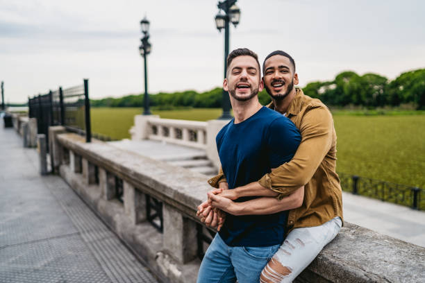 istock Gay couple embracing in park 1312127958