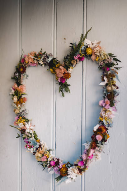 istock Heart-shaped wreath hanging on a door 1312128343