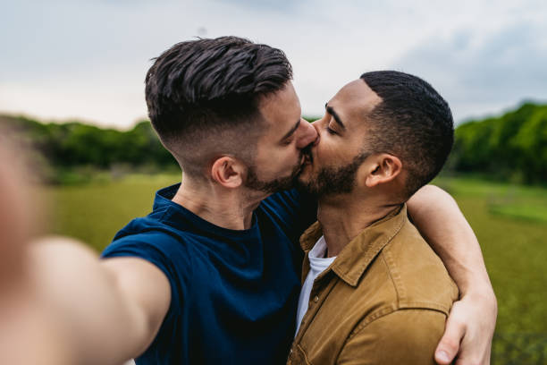 istock Gay couple making kiss selfie 1312128376