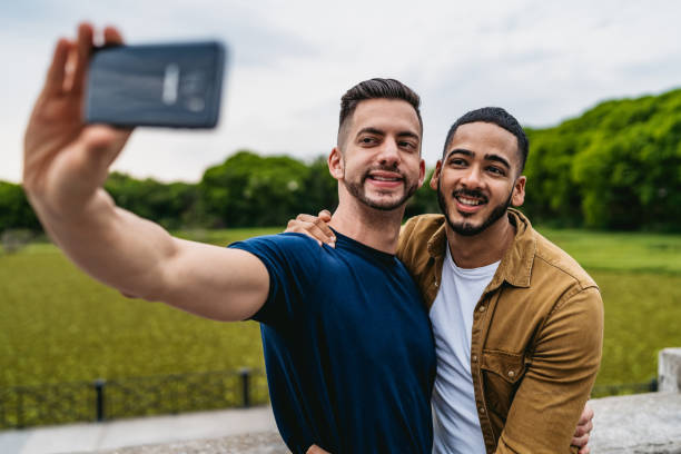 istock Gay couple making selfie in park 1312128425