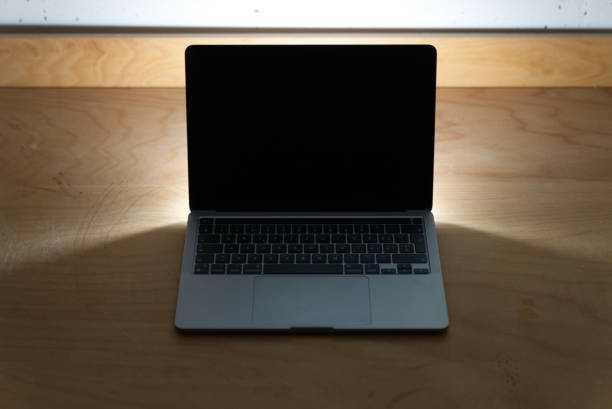 istock Laptop with black screen on table in the dark. 1312129616