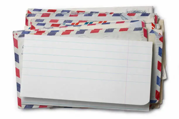 Picture of a pile of envelopes with a blank paper on the top.