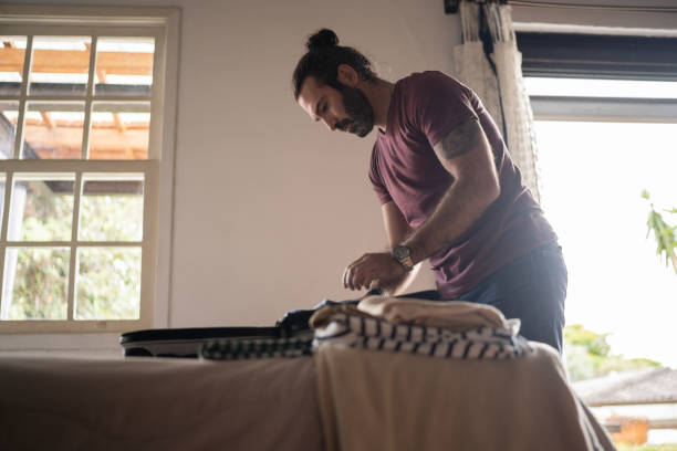 istock Man packing his backpack for a trip at home 1312131194