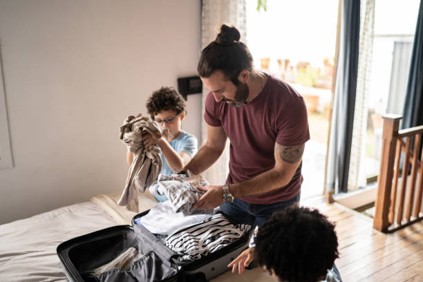 istock Kids helping father packing his suitcase at home 1312131201