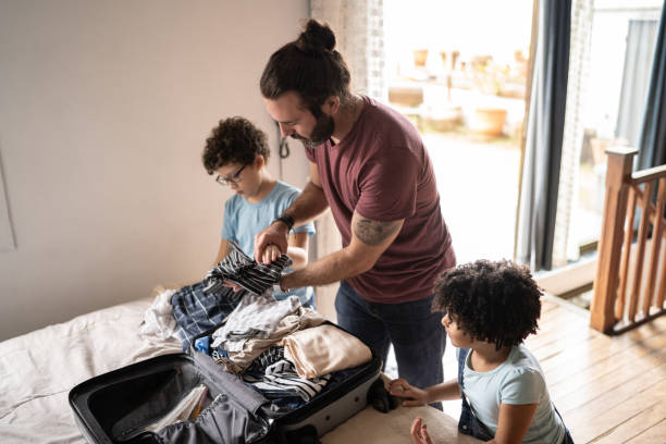 istock Kids helping father packing his suitcase at home 1312131208