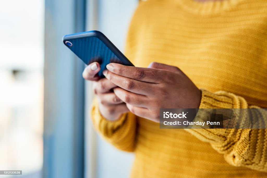 Be genuine, be remarkable, be worth connecting with Shot of an unrecognizable woman using a mobile phone indoors Telephone Stock Photo