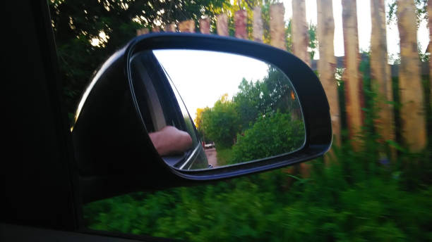istock View through the side mirror of the car. The dashboard. The windshield. Multimedia system. The sun. Nature. Side window. Side mirror. 1312134627