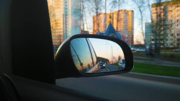 istock View through the side mirror of the car. The dashboard. The windshield. Multimedia system. The sun. Nature. Side window. Side mirror. 1312135398