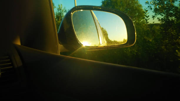 istock View through the side mirror of the car. The dashboard. The windshield. Multimedia system. The sun. Nature. Side window. Side mirror. 1312135521