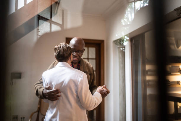 istock Senior couple dancing at home 1312135680
