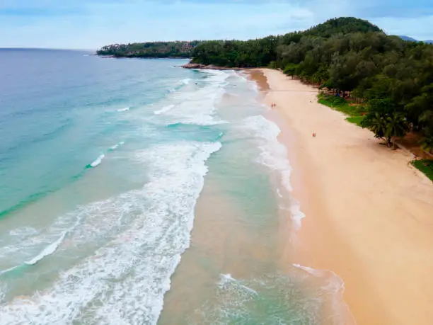 Photo of top view drone Beautiful topical beach with white sand. Top view empty and clean beach. Beautiful Phuket beach is famous tourist destination at Andaman sea.