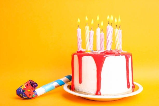 istock White cake with red icing and candles 1312137685