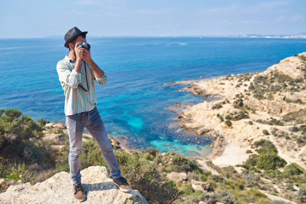 istock A hipster tourist uses a vintage camera while on vacation 1312138807