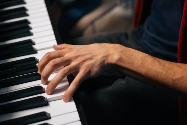 istock Top view of unrecognizable musician man playing on synthesize at home studio during lesson. 1312140420