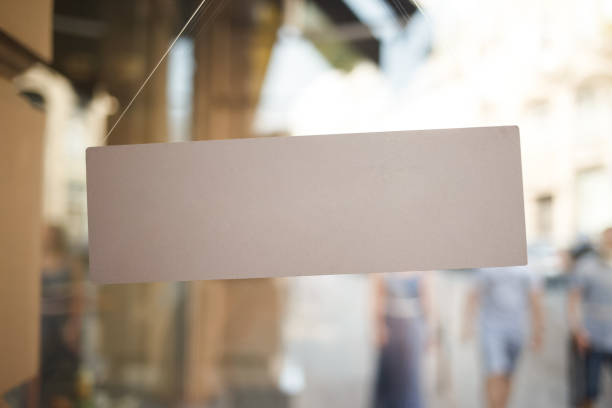 istock Blank white retail store sign on blurry background. 1312141005