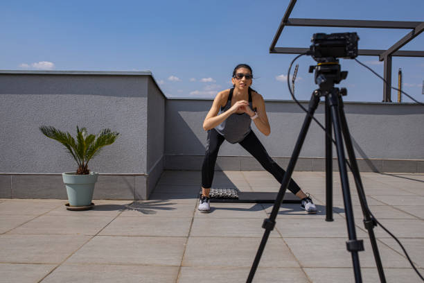 istock Female fitness instructor doing live broadcast from balcony 1312141339